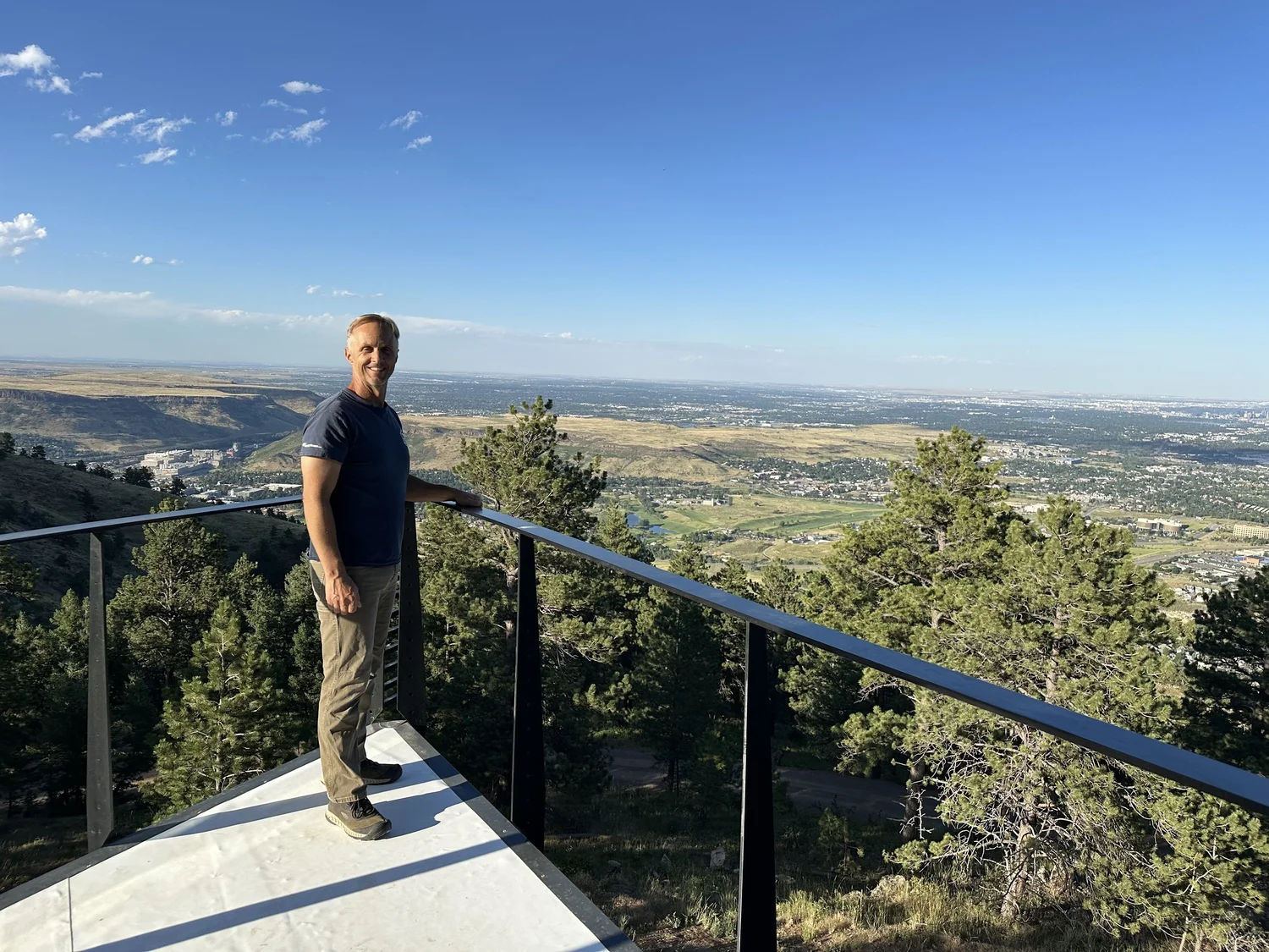 On a deck with a wide mountain view