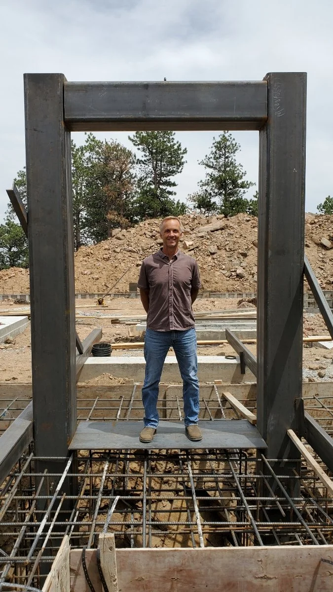 Standing inside a tall steel frame over rebar