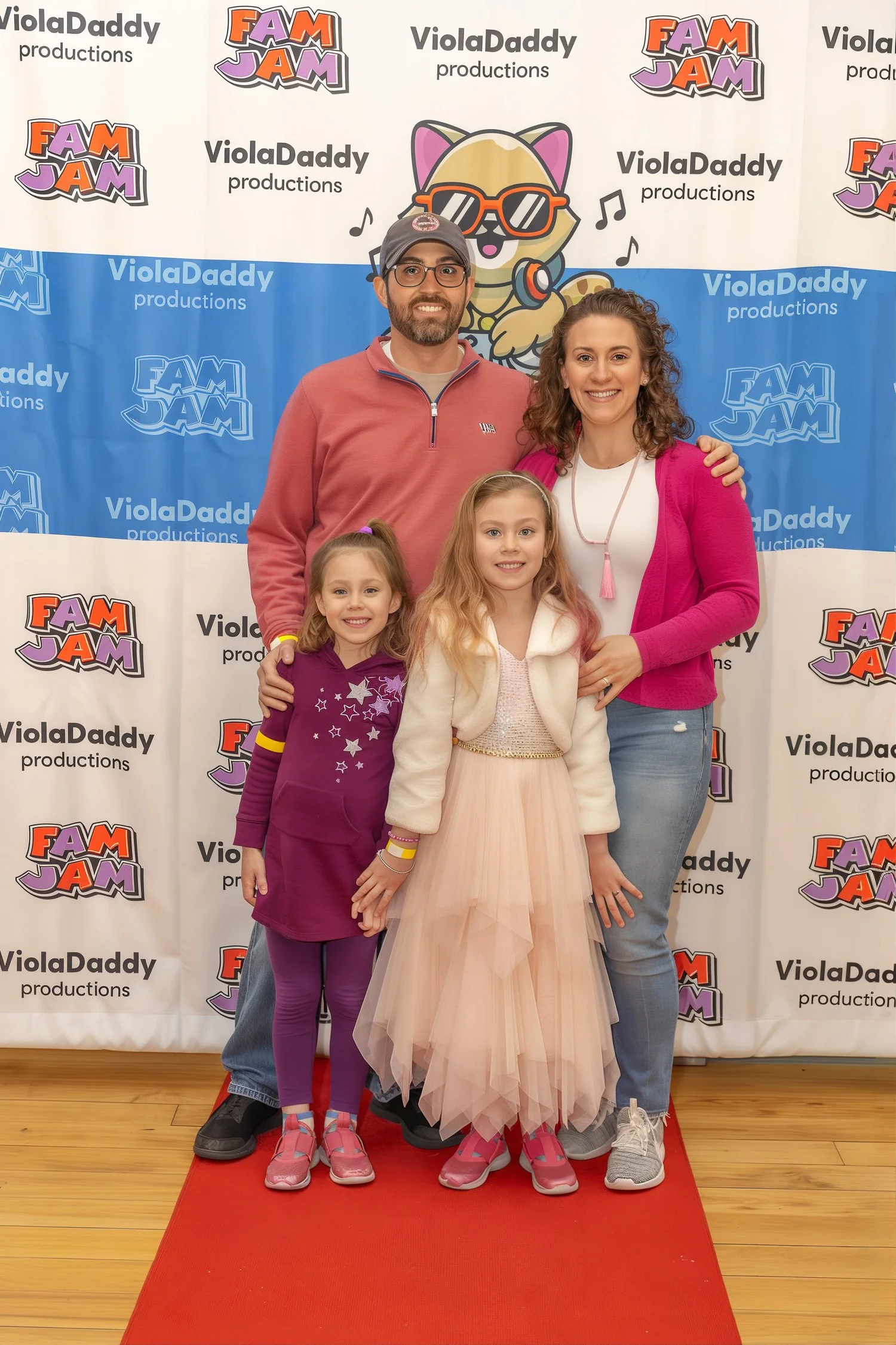 A family posing on the Fam Jam red carpet