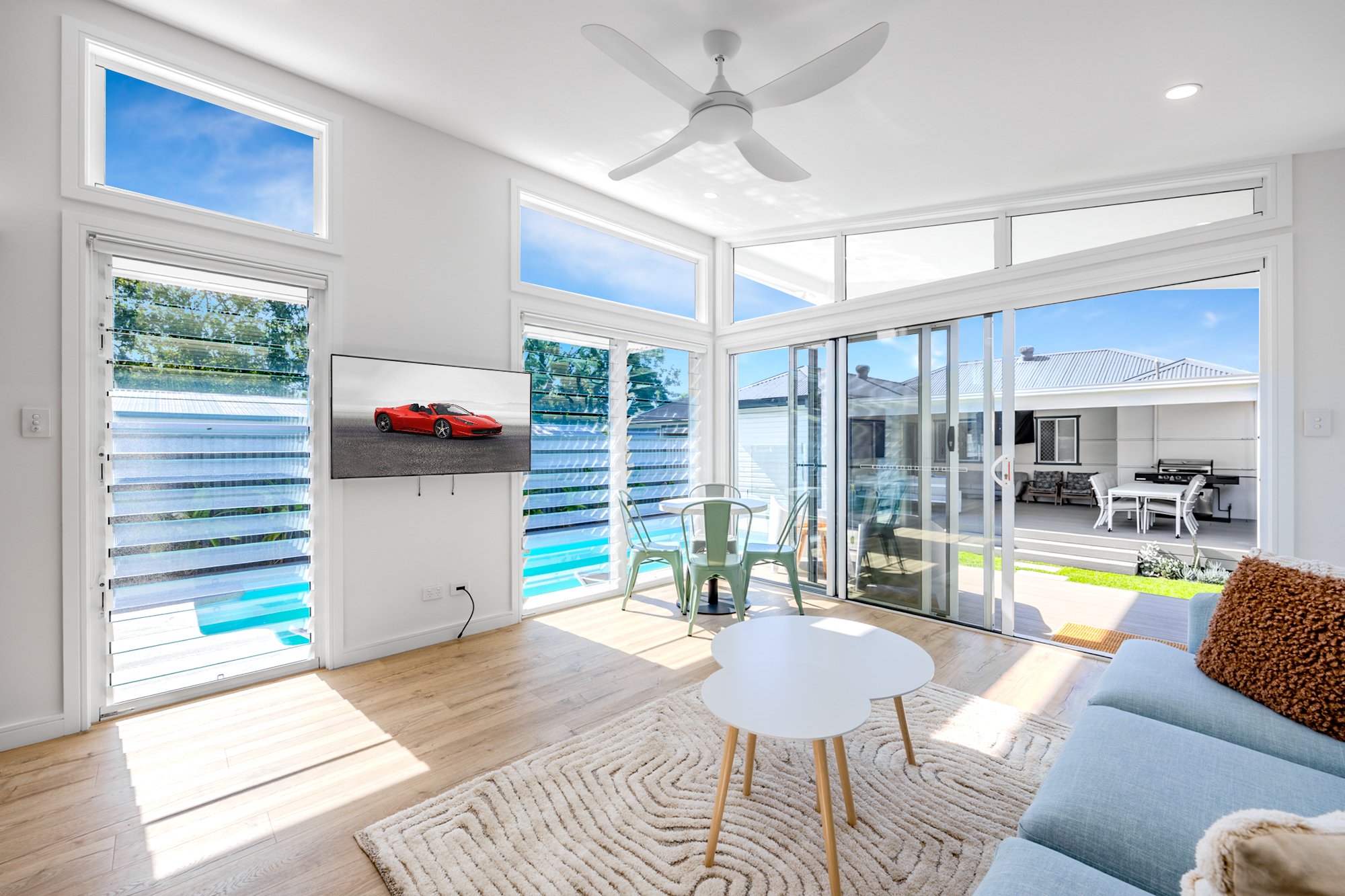Bright, modern Airbnb living room with natural light, timber flooring, neutral tones, and clean styling — ideal for a relaxing short-stay experience.