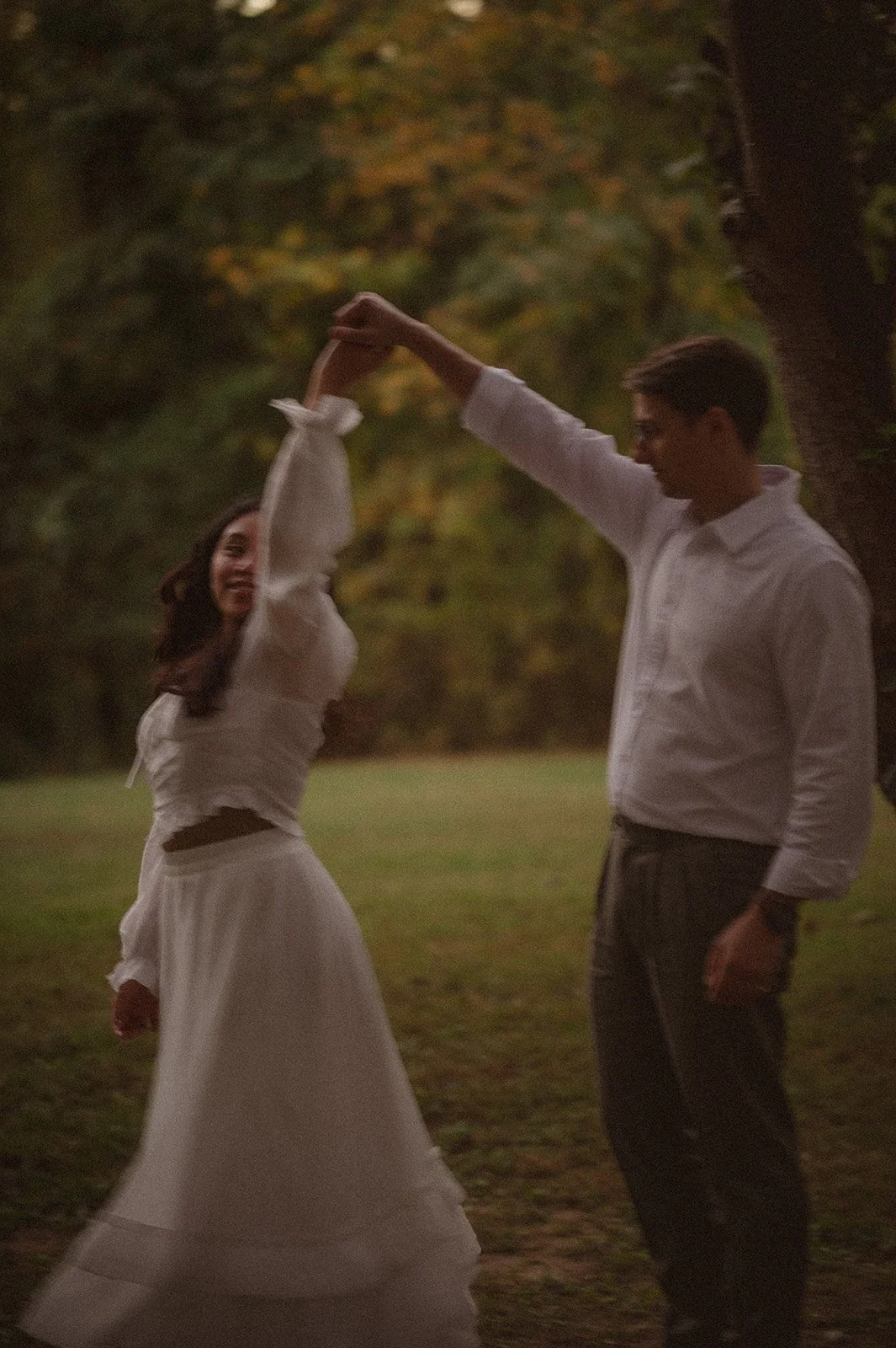 Couple dancing in open field during Pride and Prejudice–inspired cinematic engagement photoshoot in Maryland