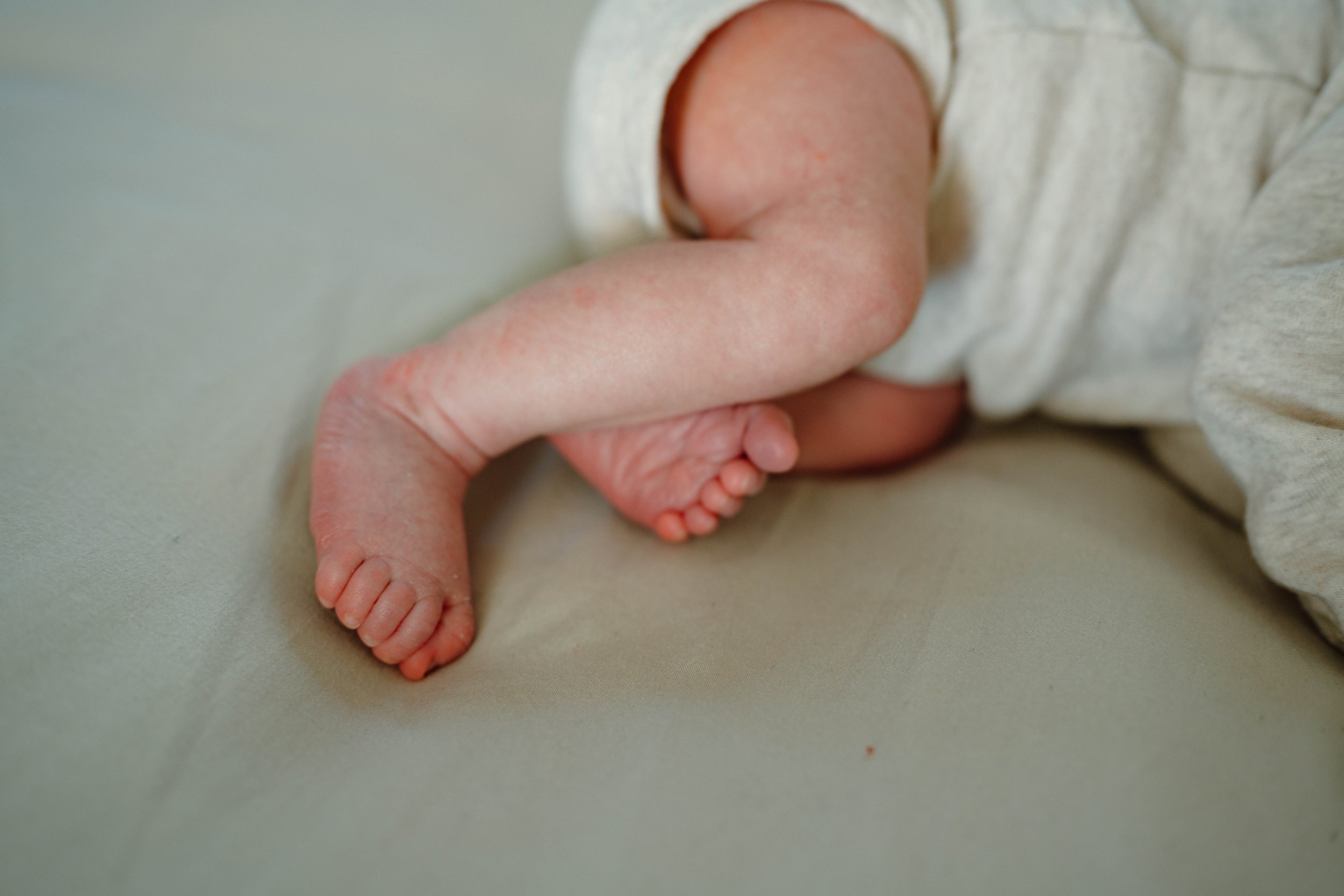 A close-up of the baby's legs, feet, and toes
