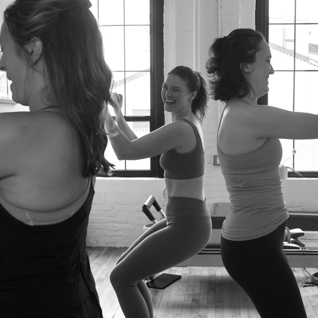 smiling women doing bicep curls and knee bends