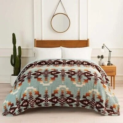 Bedroom with wooden bed frame, white bedding, southwestern patterned blanket, cactus plant on the left, small nightstand with flowers and a lamp on the right, round mirror hanging above the bed.