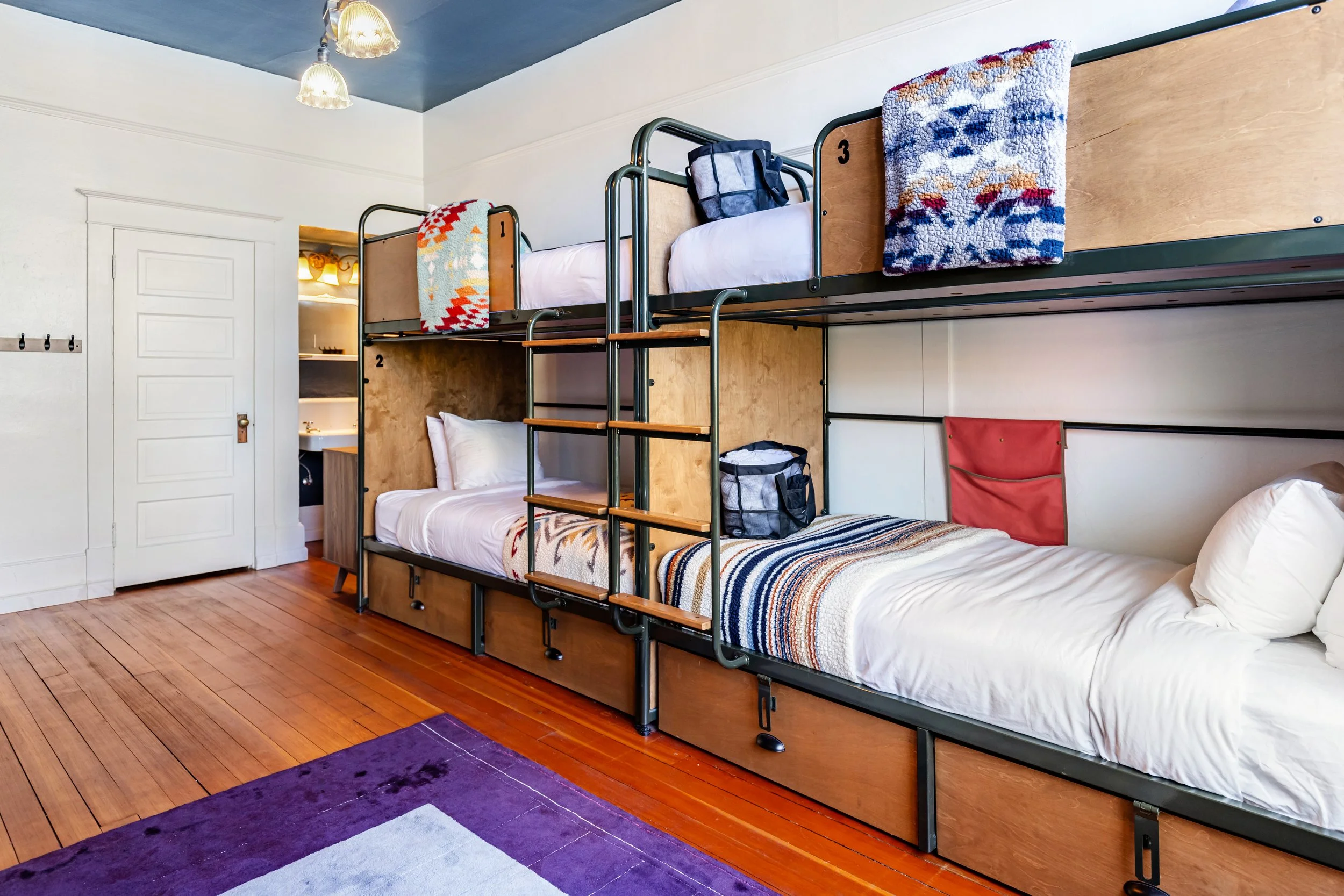 4 Adult Bunk Beds in a Premium Bunk Room facing Main Street at The Columbia Hotel.