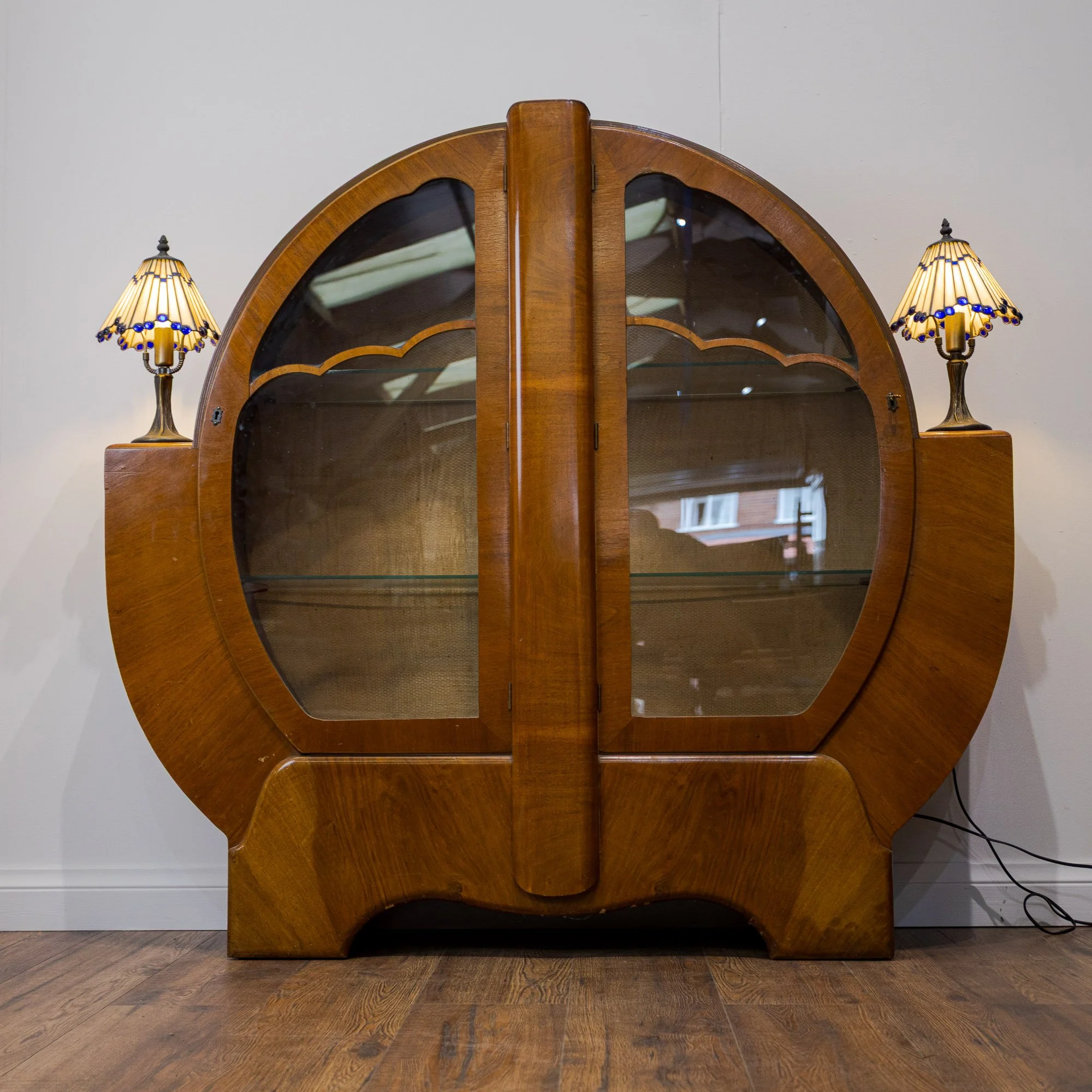 Pair of Tiffany Style Geometric Art Deco Table Lamps on a walnut art deco display cabinet