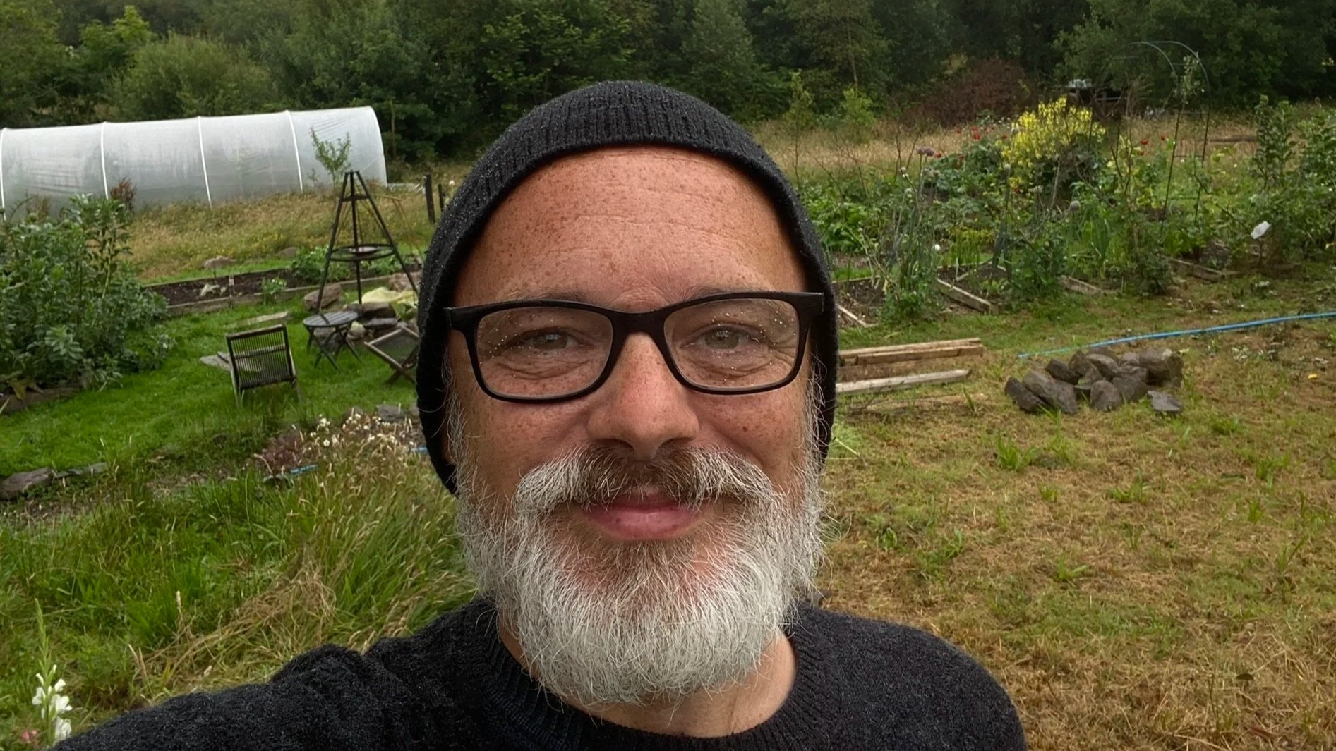 Person wearing a beekeeping suit and veil outdoors