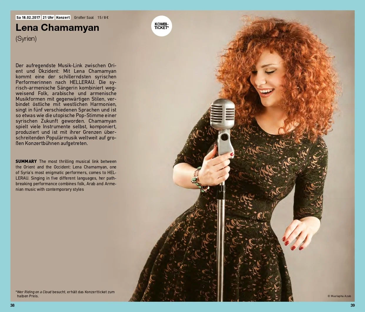 A woman with curly red hair wearing a black lace dress, holding a vintage microphone, smiling, against a plain beige background.