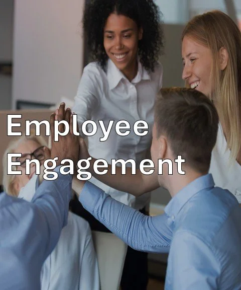 Group of diverse employees high-fiving in an office, with text overlay "Employee Engagement."