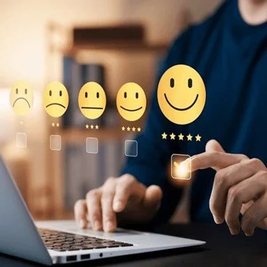 Person selecting a five-star smiley face to give feedback, with other smiley faces representing different satisfaction levels.