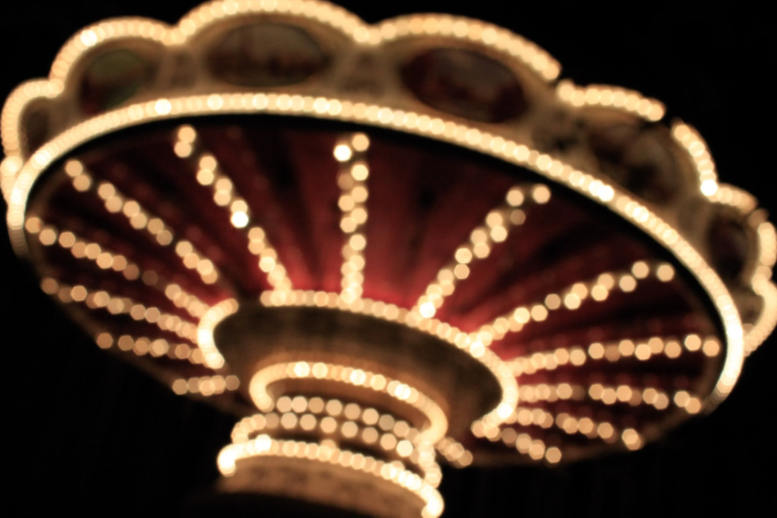A personal photography study of bokeh featuring a swing ride at Silver Dollar City, using intentional blur and glowing lights to turn motion into an abstract composition. This image received the Best Photo award in my college photography class in 201