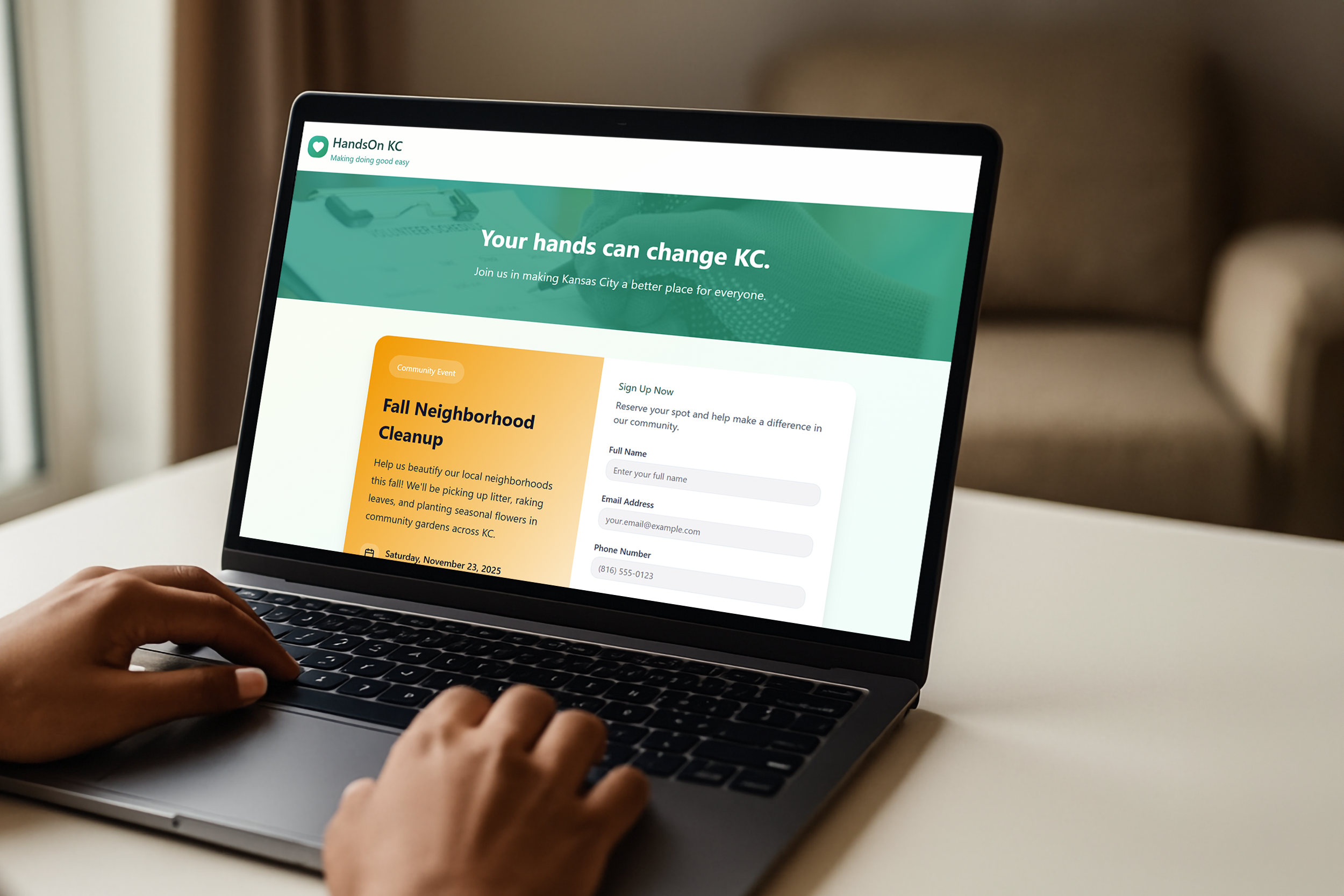 A person using a laptop that displays the HandsOn KC website, promoting community events like Fall Neighborhood Cleanup in Kansas City.