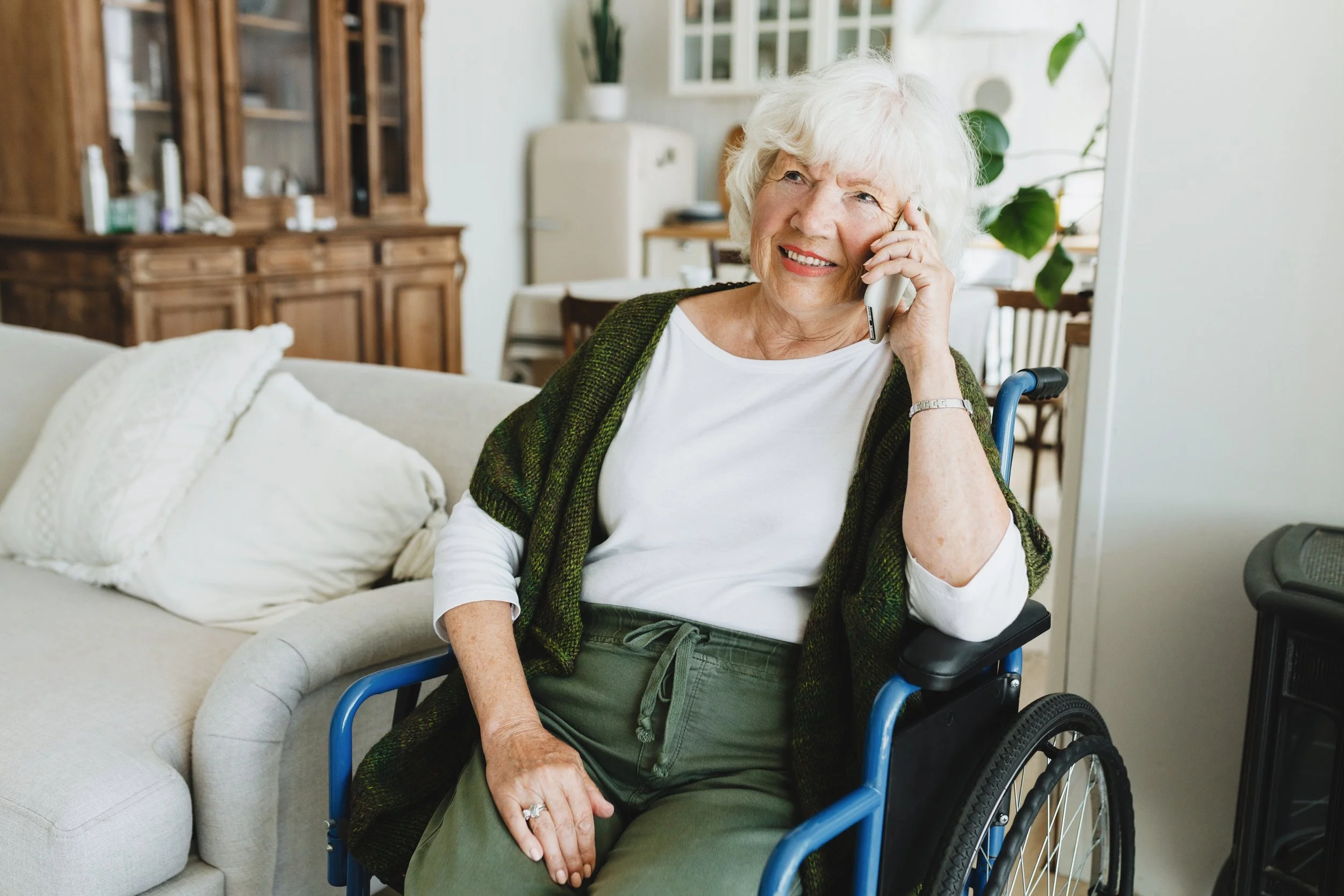 Senior on phone with long distance family caregiver