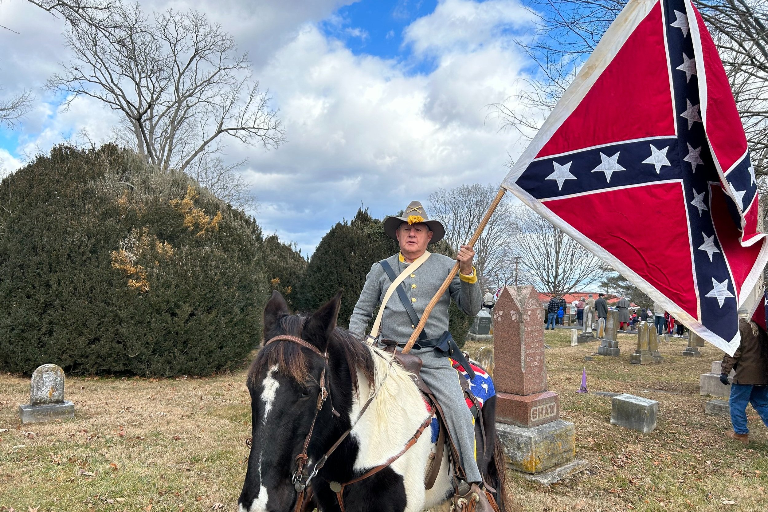  A parade participant on horseback holds a Confederate battle flag on Saturday, January 13. Source:  The Spectator . 