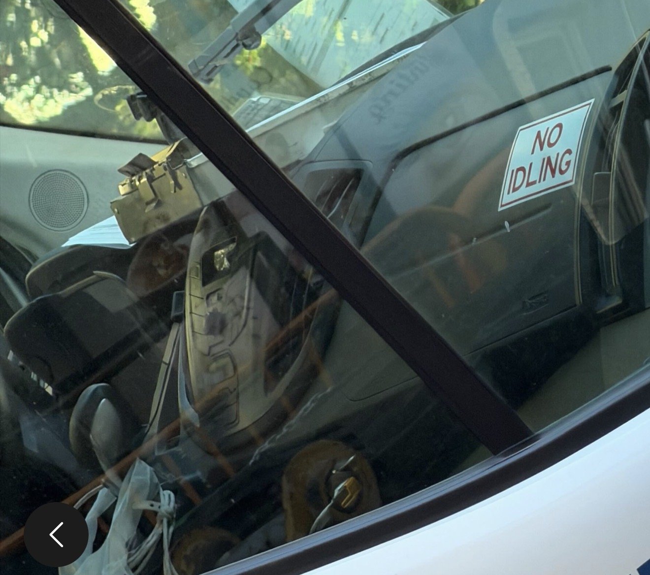 Truck dashboard showing "No Idling" sticker.