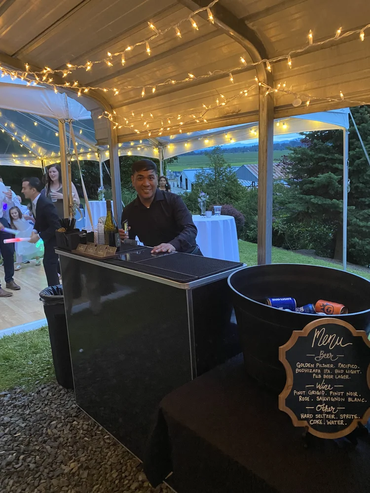 A Tsunami portable bar under string lights