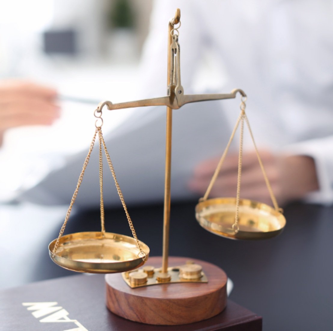 scales-of-justice-sitting-on-someones-desk