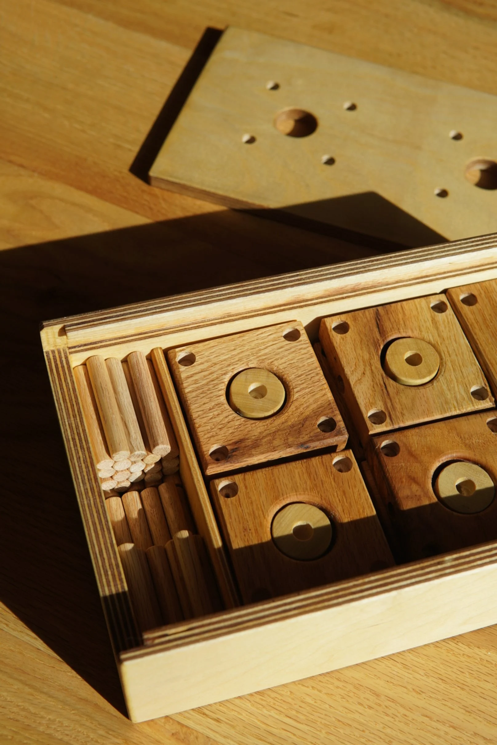 A wooden box containing a set of playful blocks.
