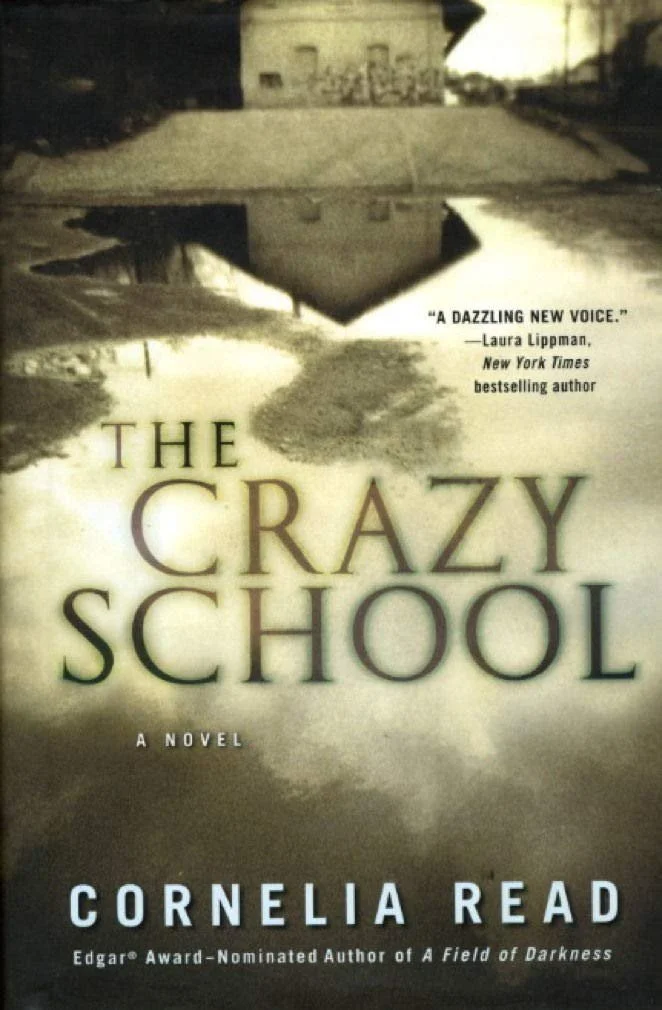 Book cover of 'The Crazy School' by Cornelia Read, featuring a desolate street scene with a muddy road and overcast sky, alongside a quote praising the book.