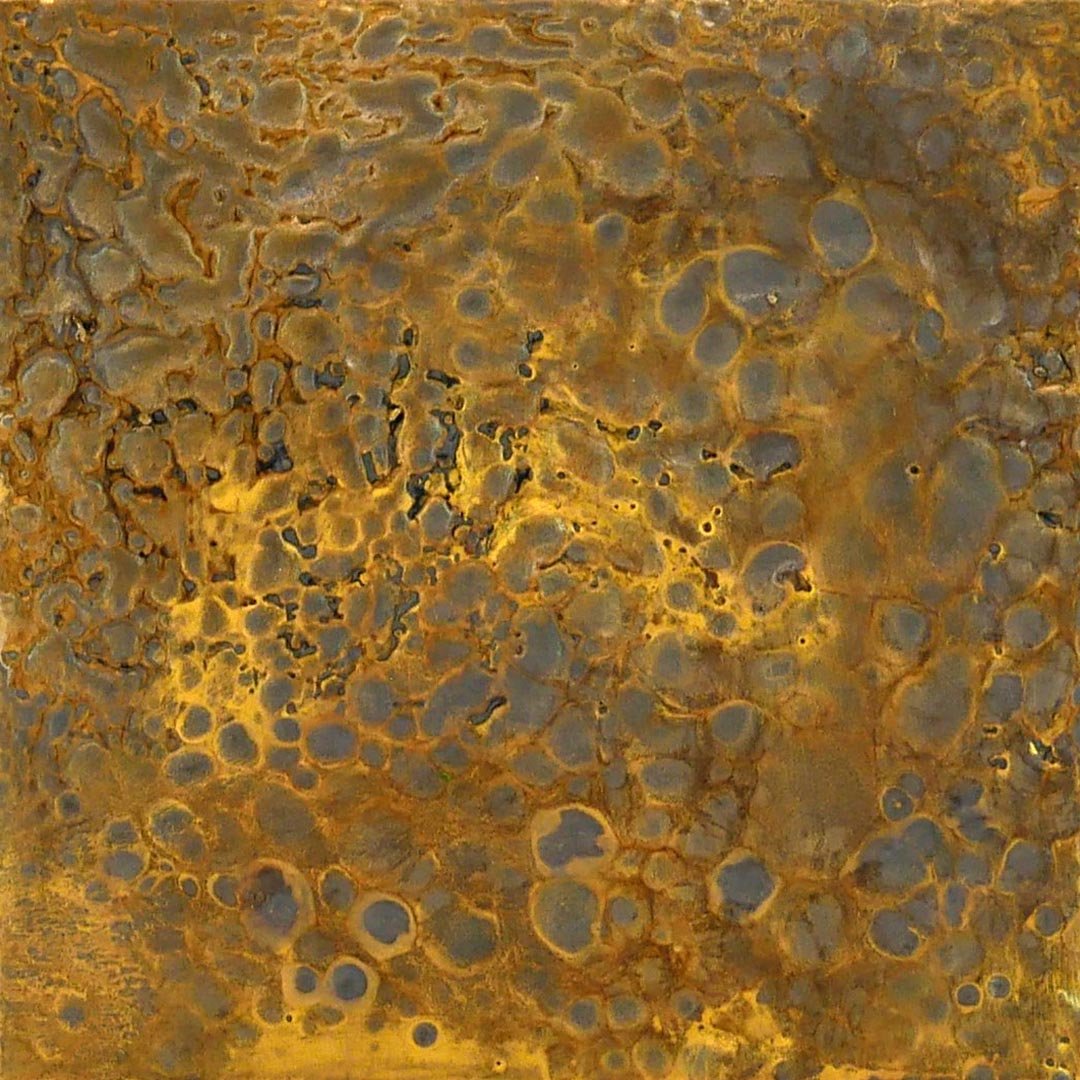 Close-up of a rusty, textured metallic surface with circular patterns and orange-brown corrosion.