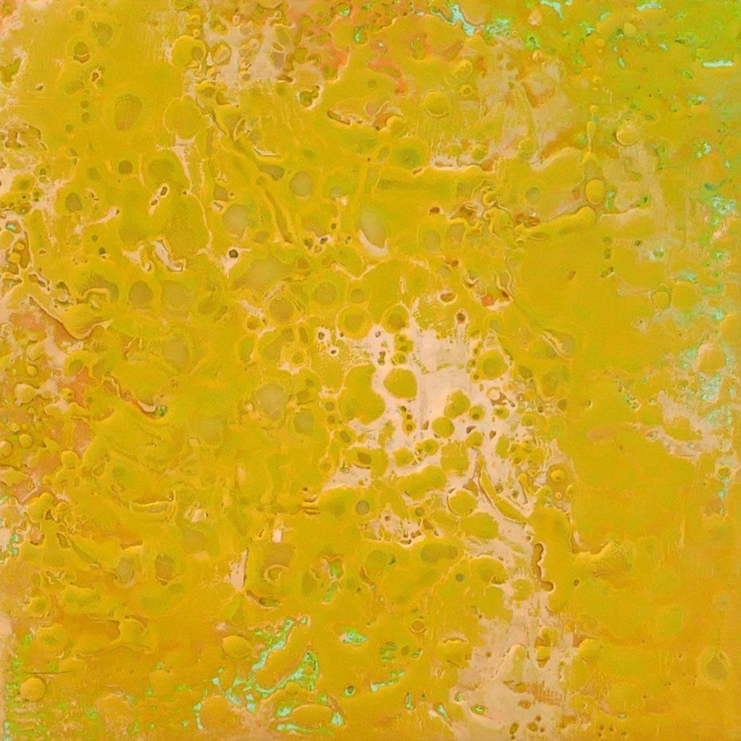 Yellow abstract pattern with various spots and streaks.