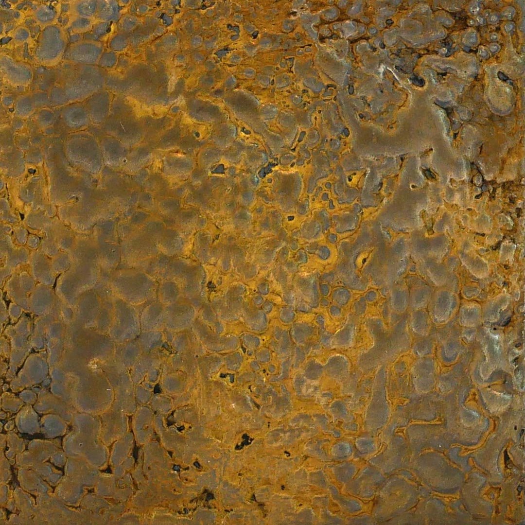 Close-up of a rusty, corroded metal surface with orange and brown patina and pitted texture.