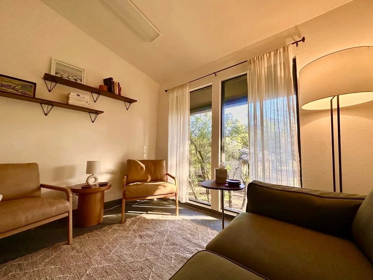 His therapy room in Austin, sunlit, with two armchairs and a sofa