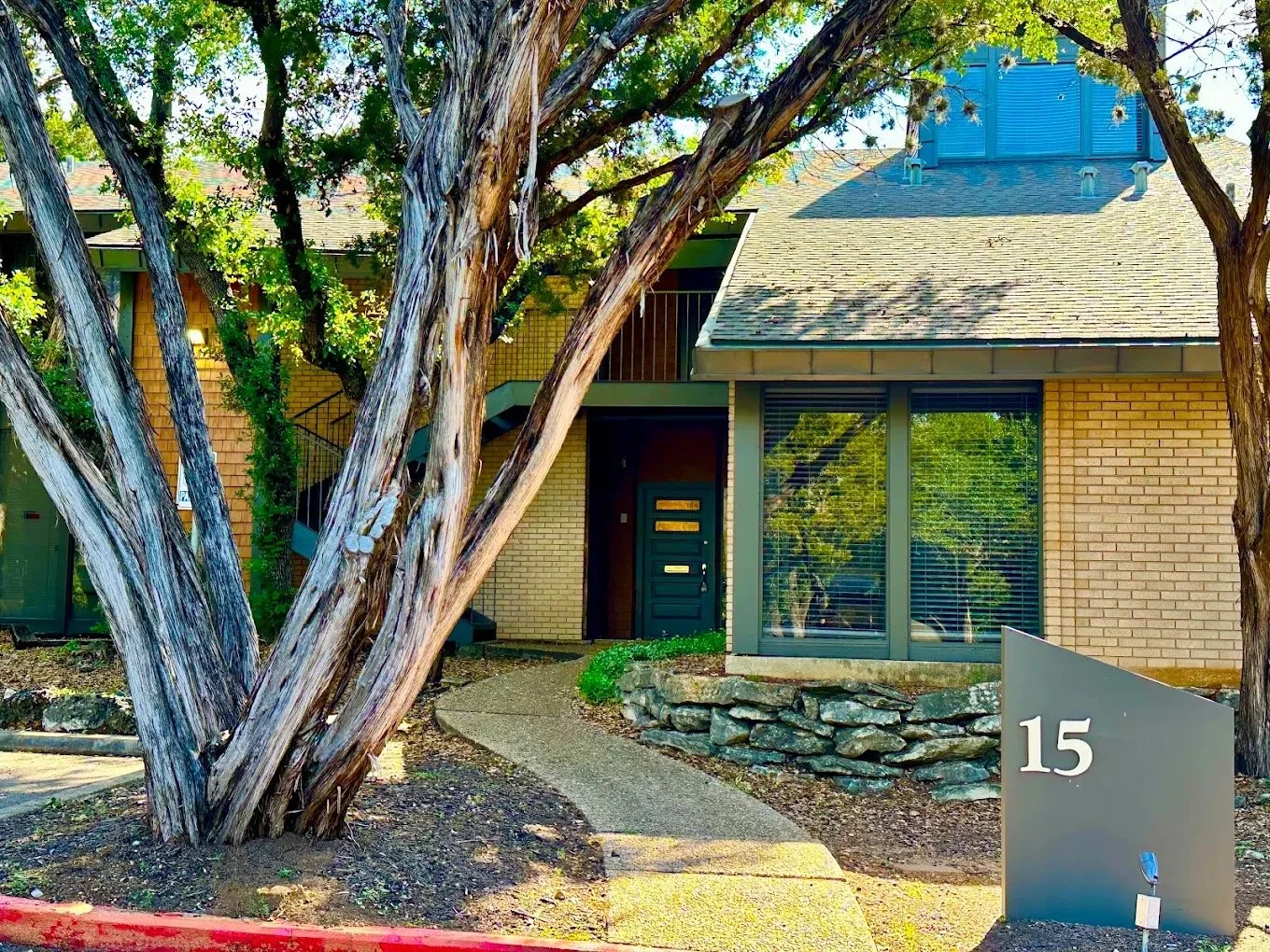 The entrance to Building 15 at his Austin office, under the trees