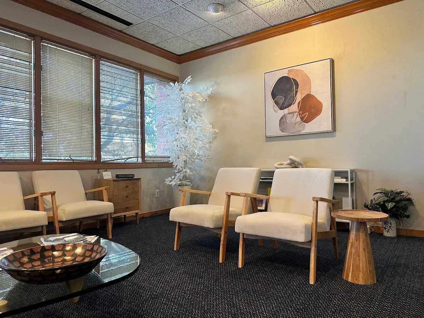 The waiting room at his Austin office, with four cream armchairs