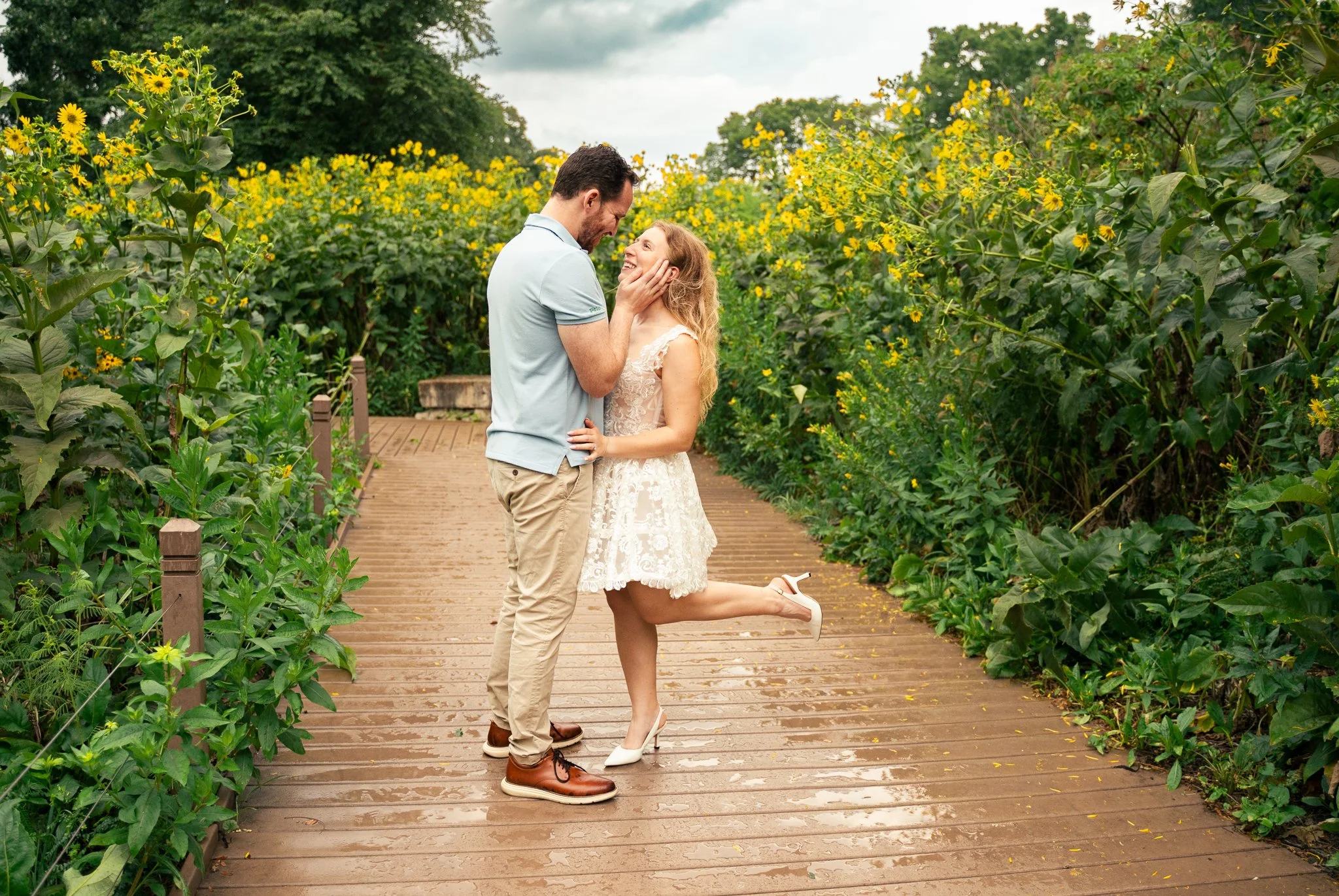 Lincoln Park Chicago Illinois Engagement Photographer | Bride in lace white dress popping up leg looking at groom as he caresses her cheek | Midwest Wedding and Engagement Photography Sessions