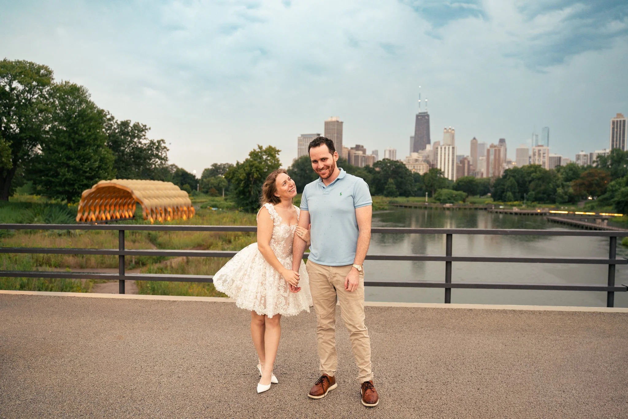 Lincoln Park Chicago Illinois Engagement Photographer | Bride in lace white dress holding on to grooms arm, Honeycomb in background | Midwest Wedding and Engagement Photography Sessions