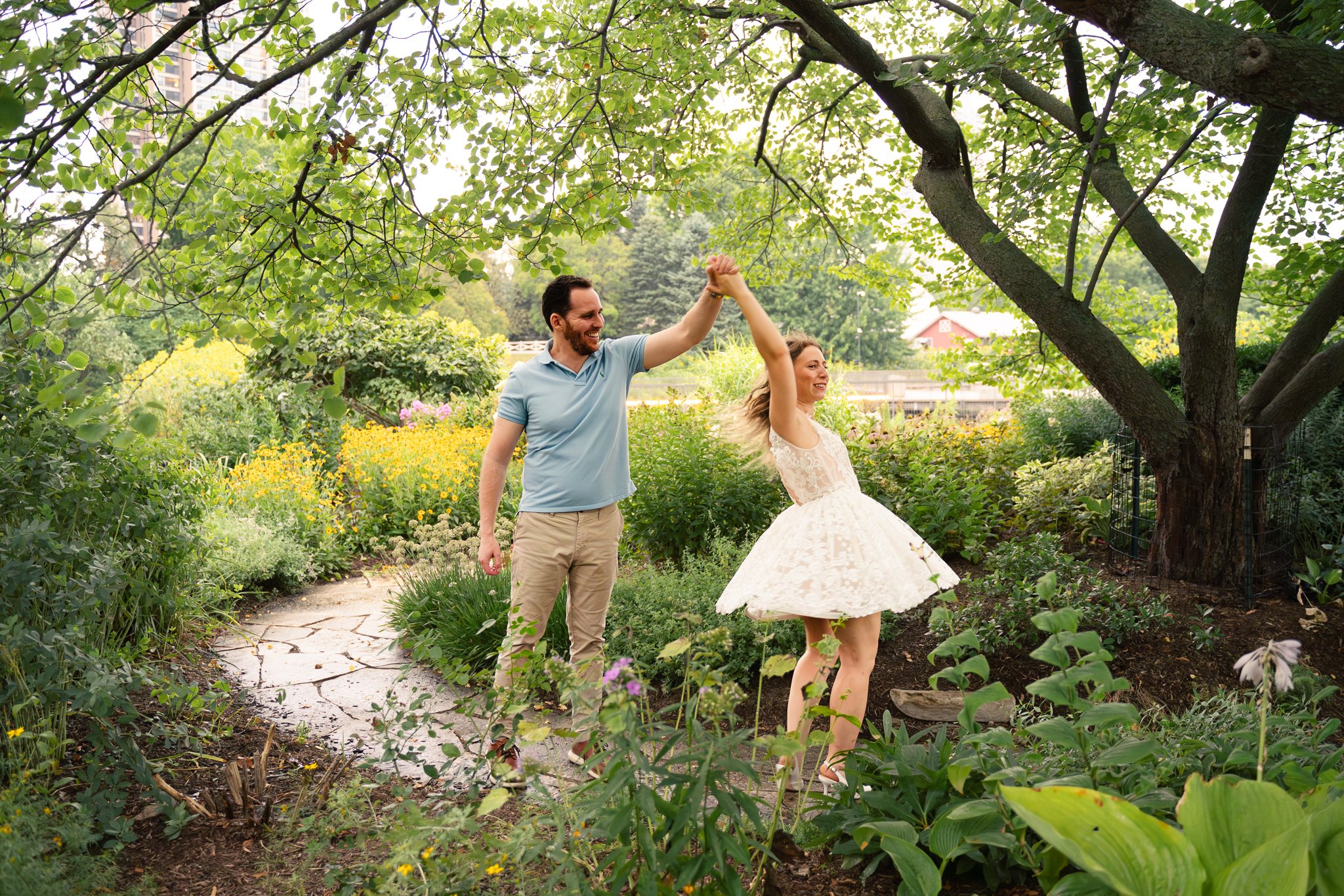 Lincoln Park Chicago Illinois Engagement Photographer | Bride in lace white dress holding on to grooms arm, Honeycomb in background | Midwest Wedding and Engagement Photography Sessions