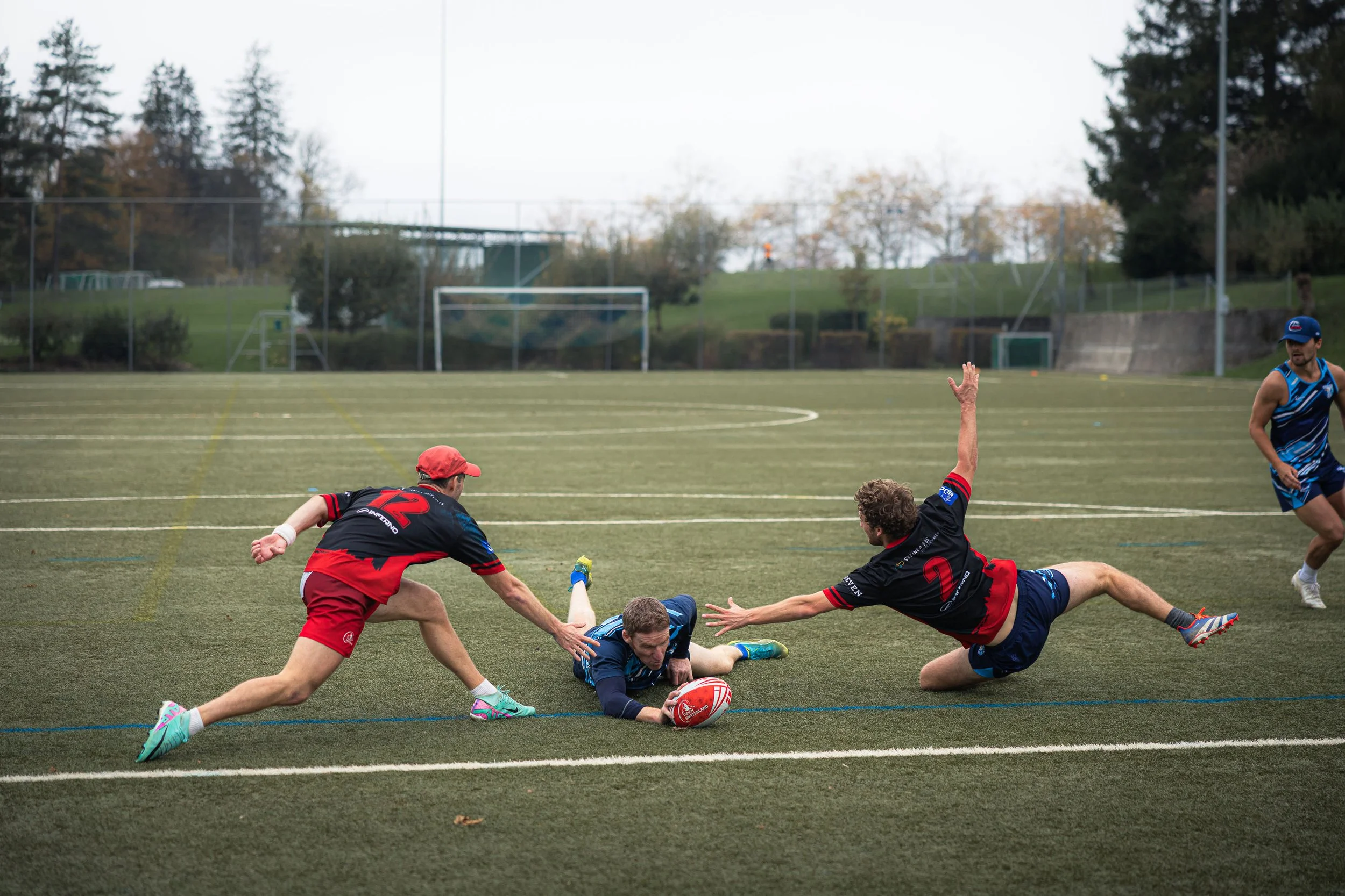 Joueur de touch rugby qui plonge pour marquer un point. Photo de Rüdi Welter