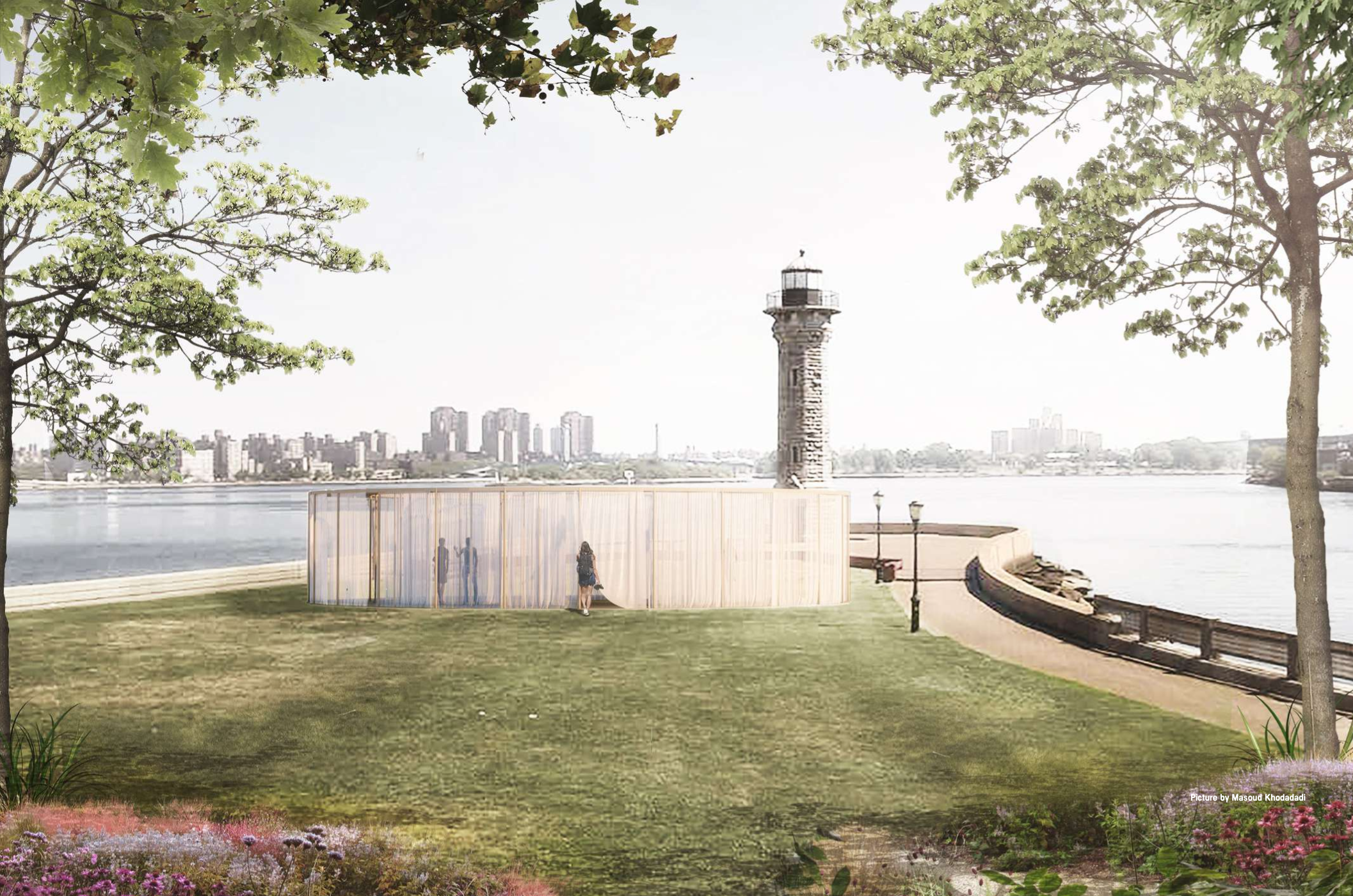 A park overlooking a body of water with a lighthouse, trees, a curved pathway, and a city skyline in the background. There is a modern structure with sheer curtains and a person standing next to it.