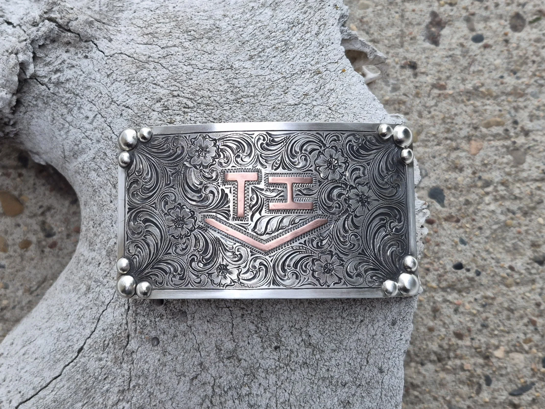 Silver engraved buckle with a copper brand