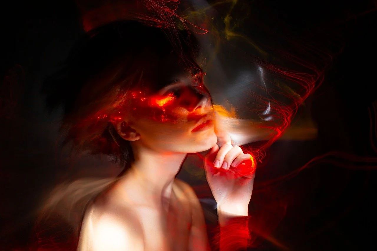 woman in thinking pose with red light swirling around her head