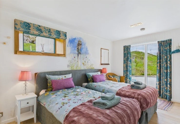 Ground floor en-suite twin bedroom with marble vanity, power shower and WC 