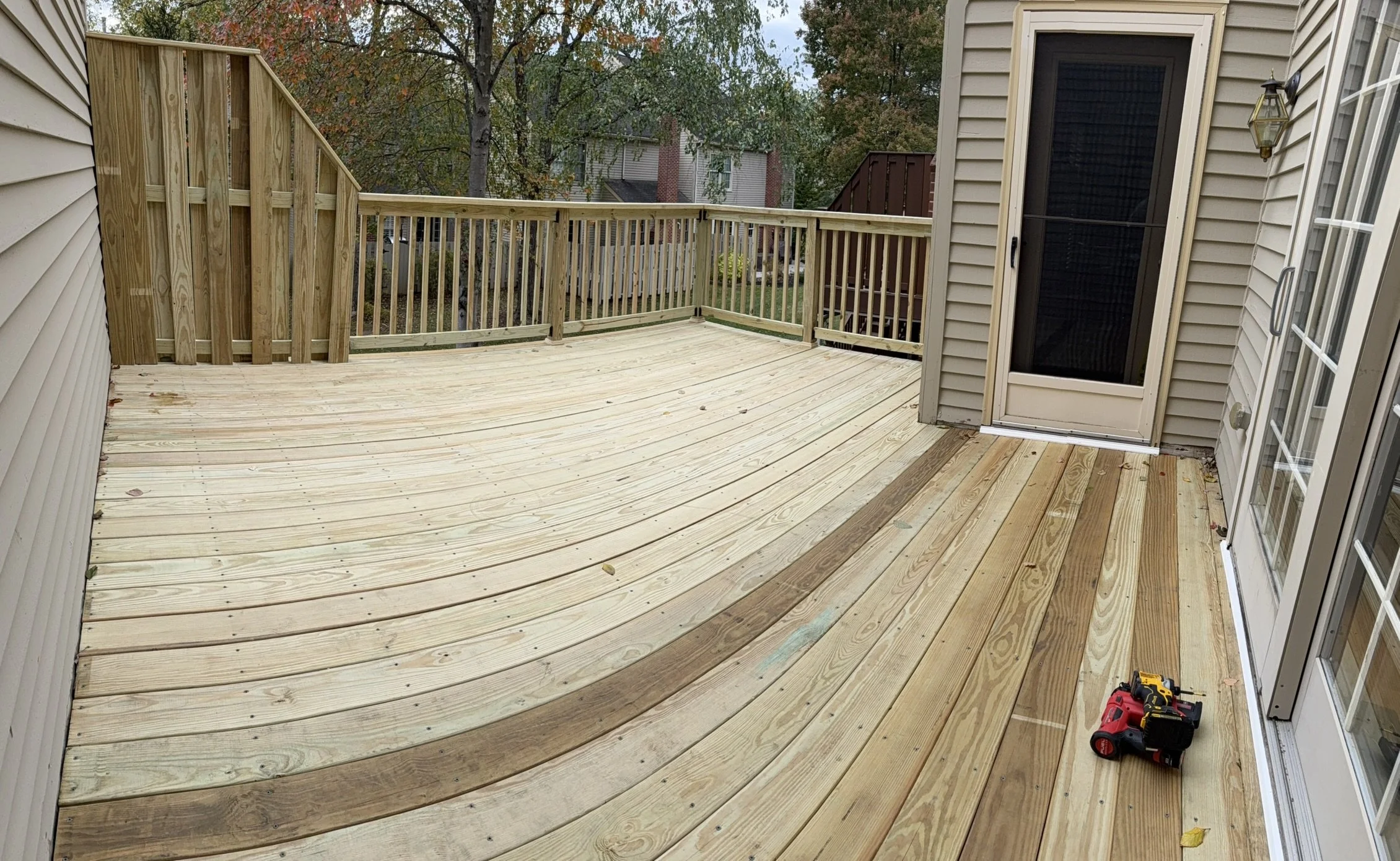 This deck had rotted deck boards and needed to be replaced. We also rebuilt the railing and privacy wall. We will be staining the deck in the Spring!