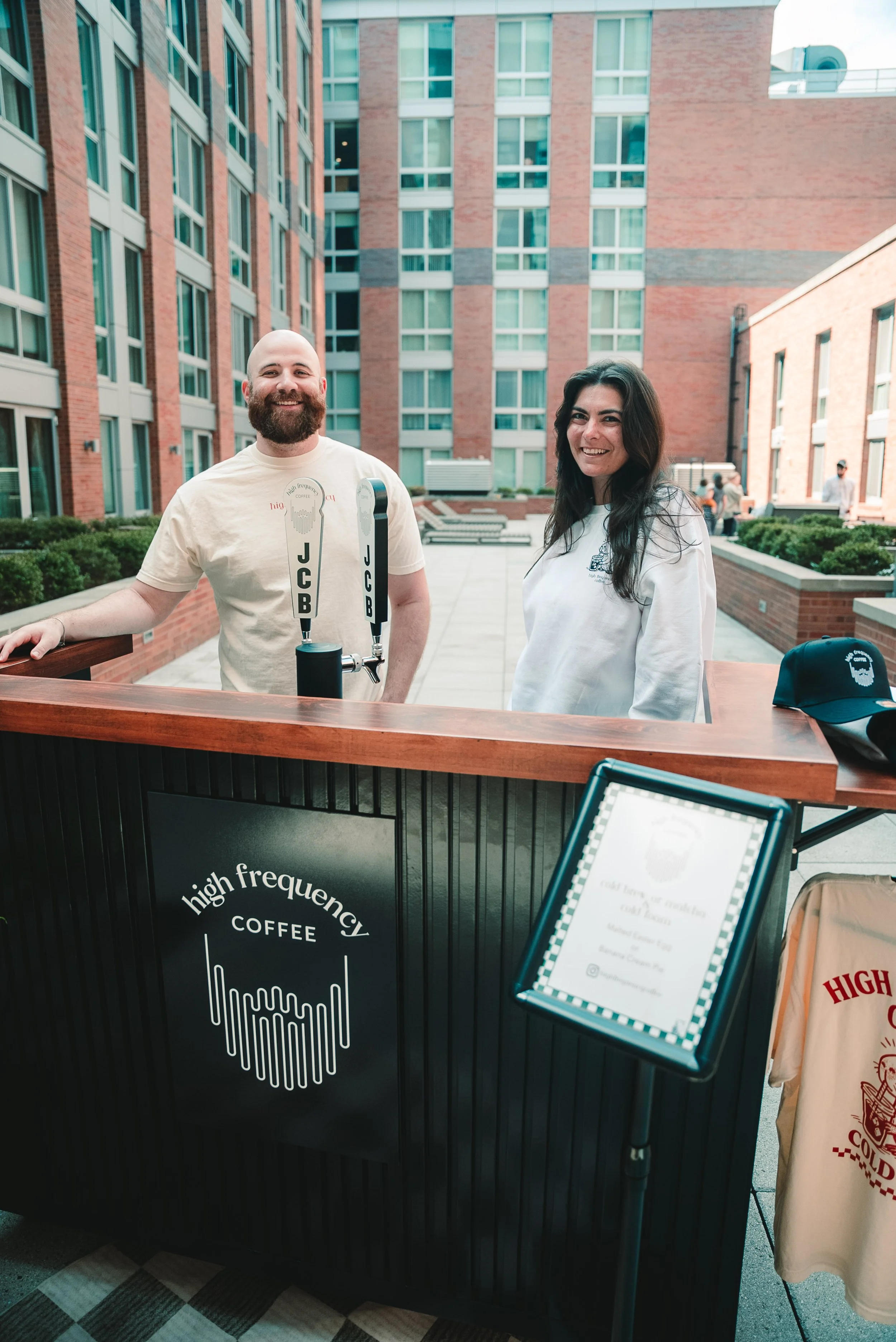 A mobile coffee cart catering service with a professional barista serving cold brew coffee drinks at an event in New Jersey