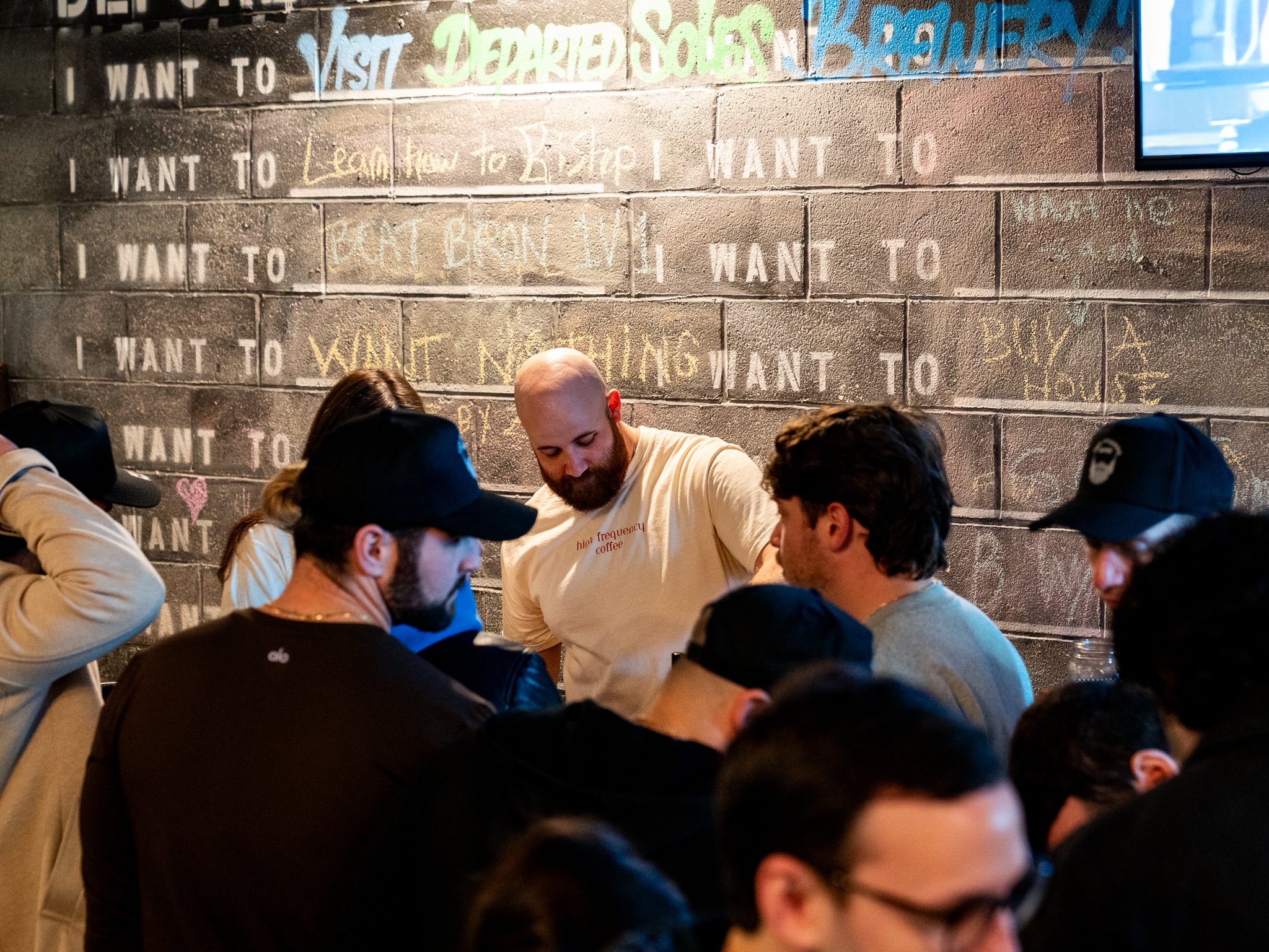 A bunch of people are hovering around the coffee catering cart, waiting to be served matcha, cold brew coffee, and cold foams with fun toppings.