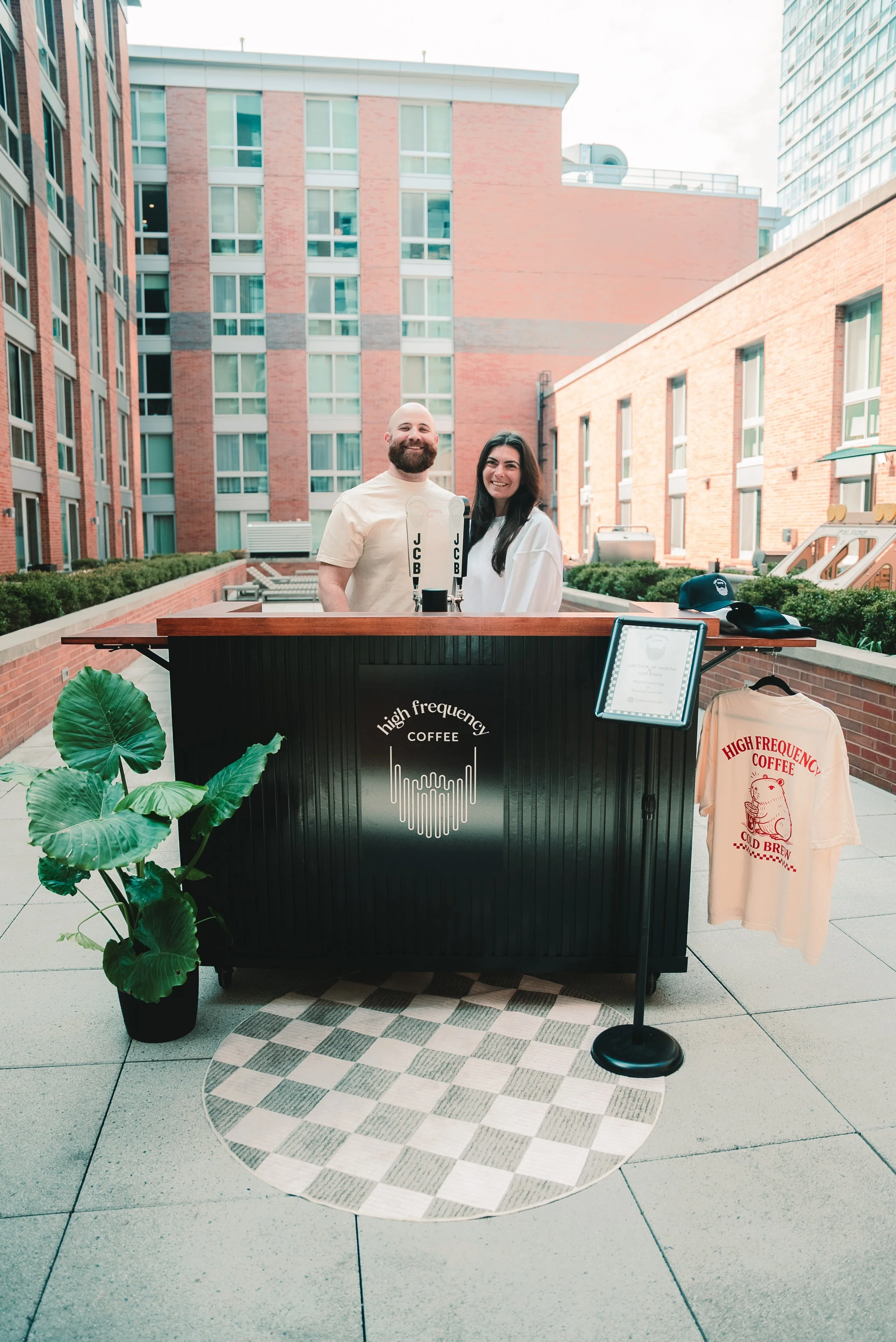 A wedding coffee bar setup in New Jersey featuring a mobile cold brew coffee cart and skilled barista