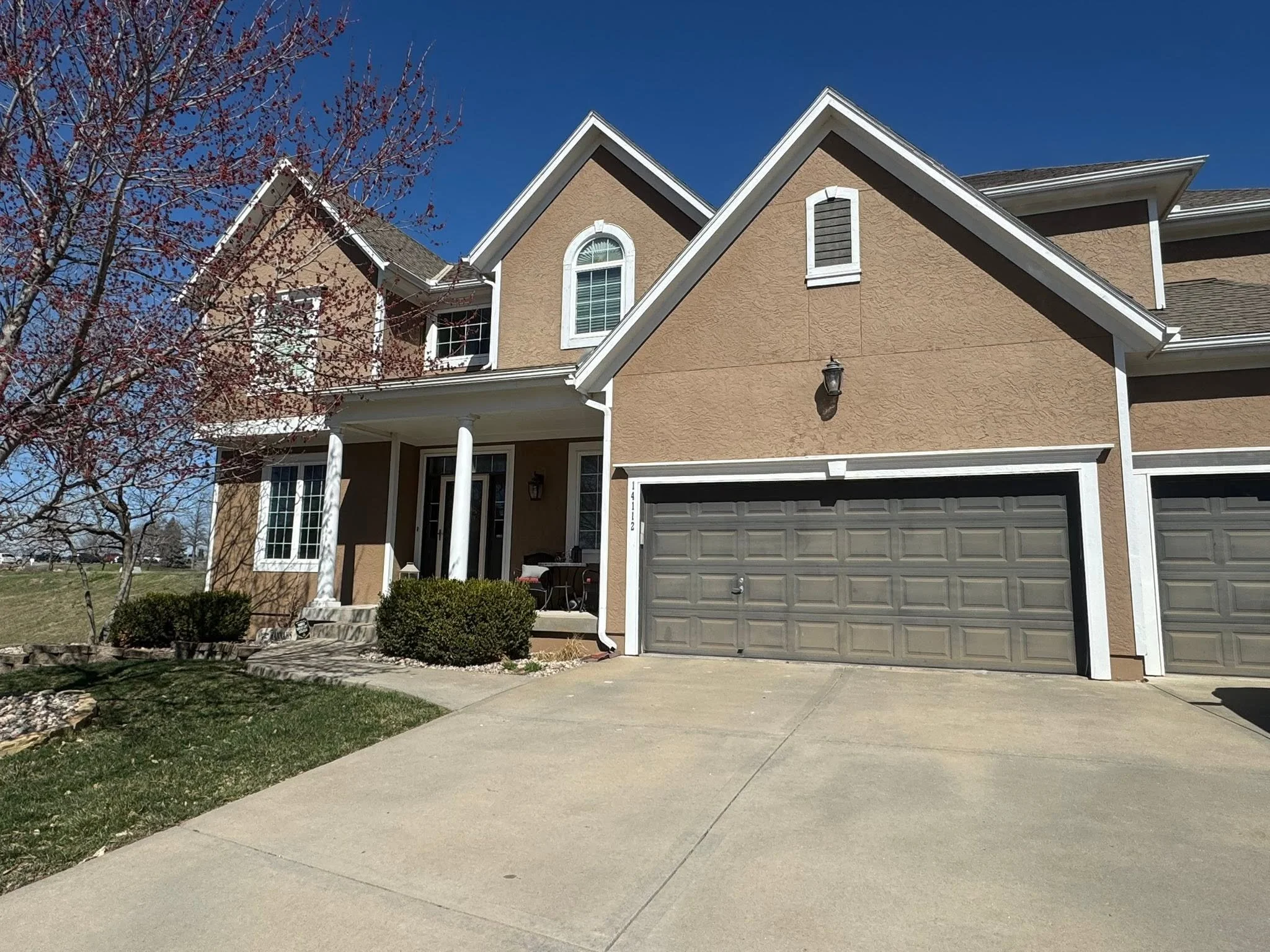 Johnson County stucco home before exterior painting in a warm brown color.