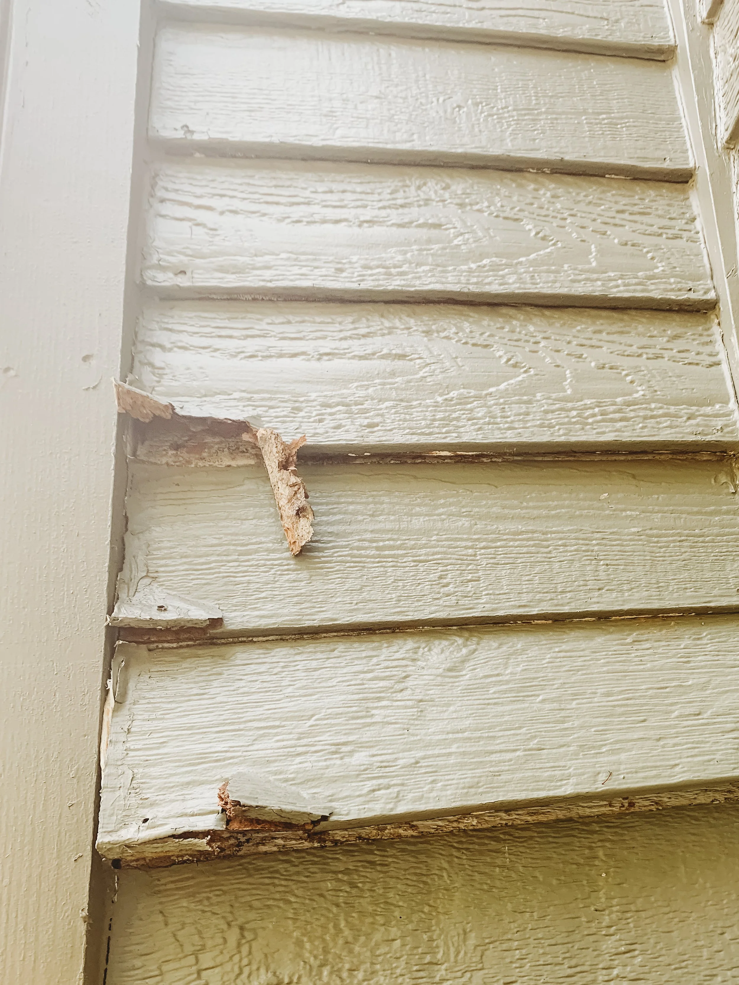 Damaged lap siding with peeling paint before exterior preparation by Gripka & Co.