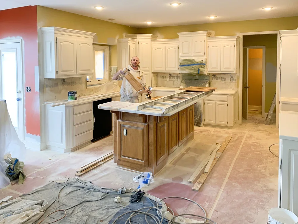 Kitchen cabinet painting preparation with cabinets, counters and adjacent surfaces protected by Gripka & Co.