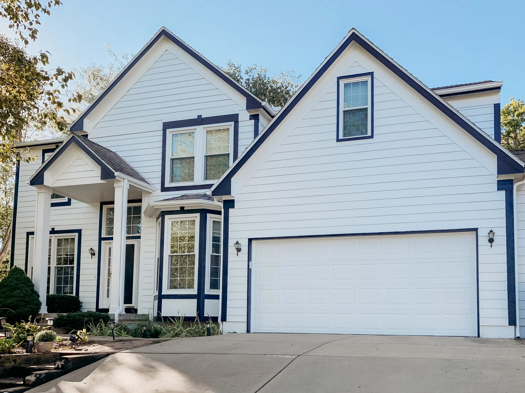 Completed Overland Park exterior painting with light siding and dark contrasting trim by Gripka & Co.