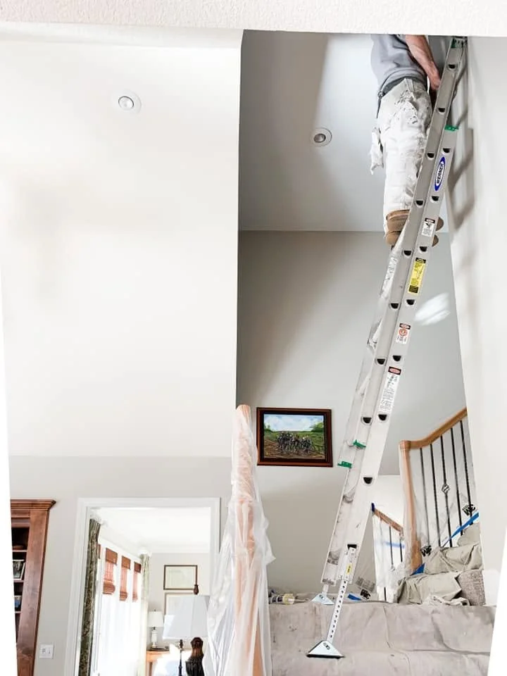 Ladder access and protection during painting of a vaulted Falcon Lakes interior.