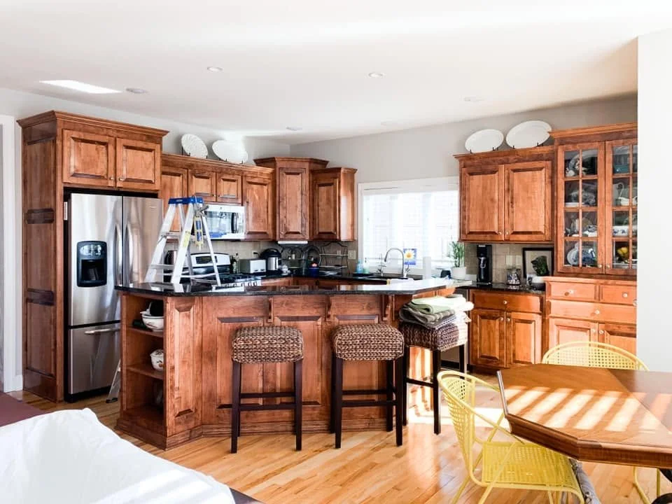Falcon Lakes kitchen and dining area after interior painting with bright ceiling and warm gray walls.