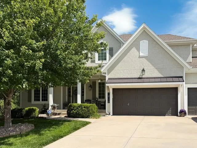 Olathe home before exterior painting with tan siding and matching trim.