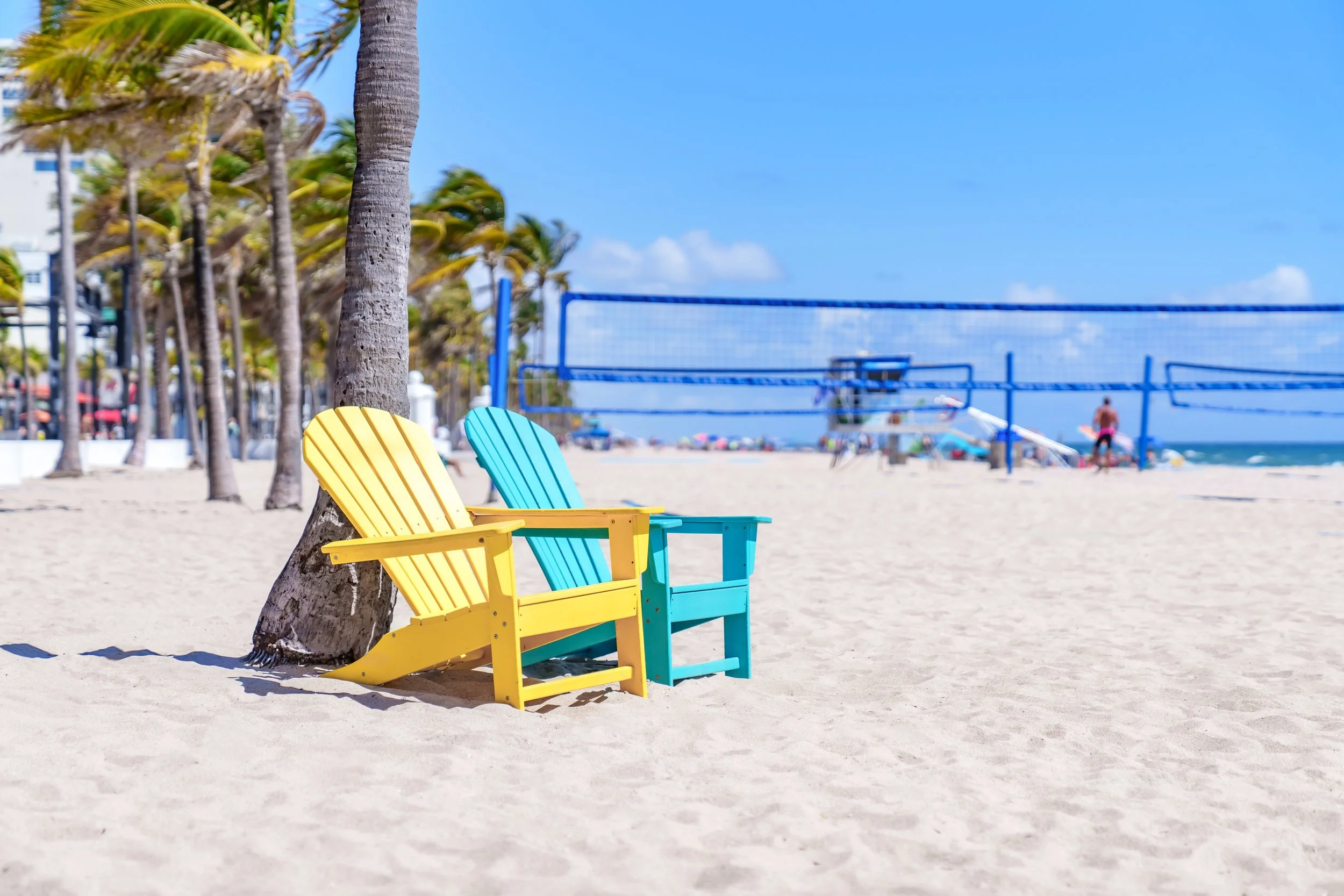 Two yellow beach chairs on a quiet South Florida sand beach