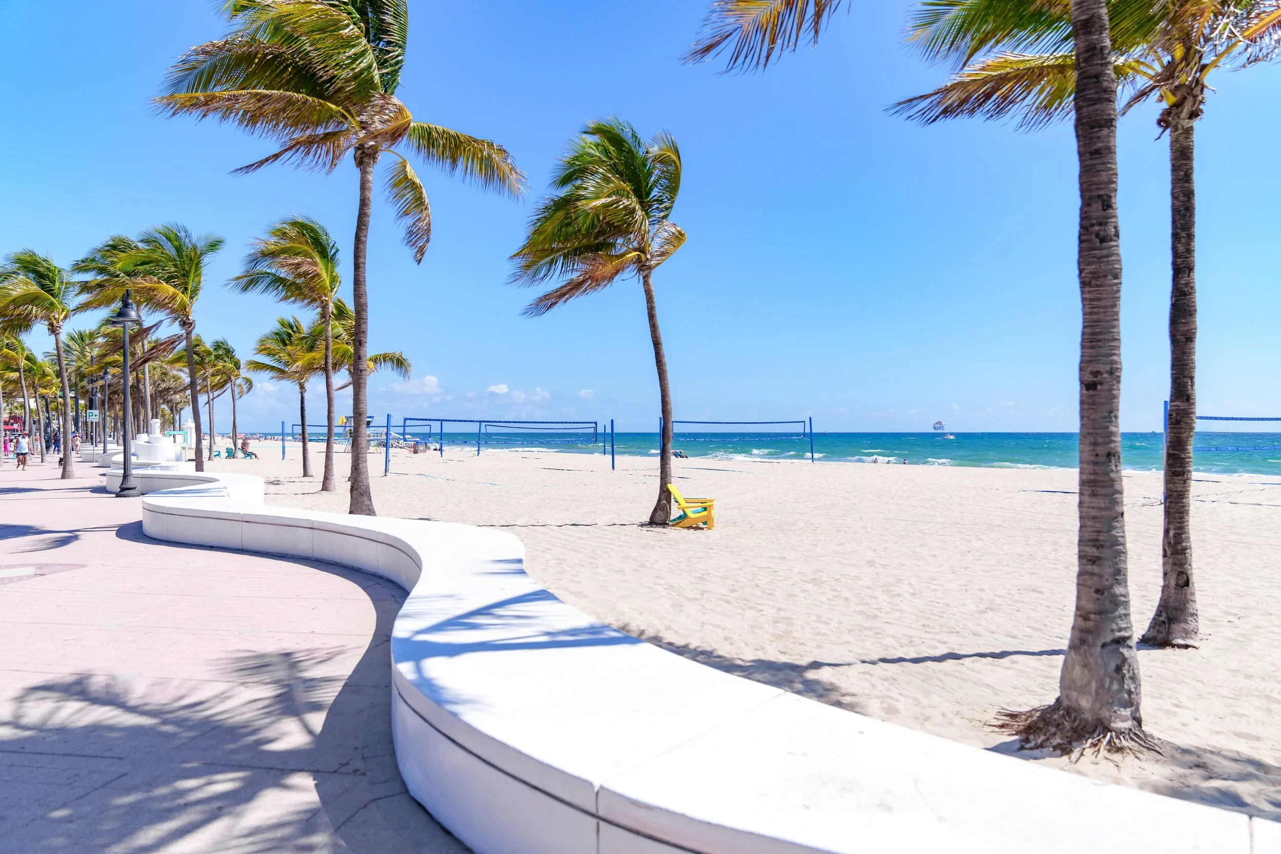 Sand pathway between palm trees leading to the ocean in South Florida
